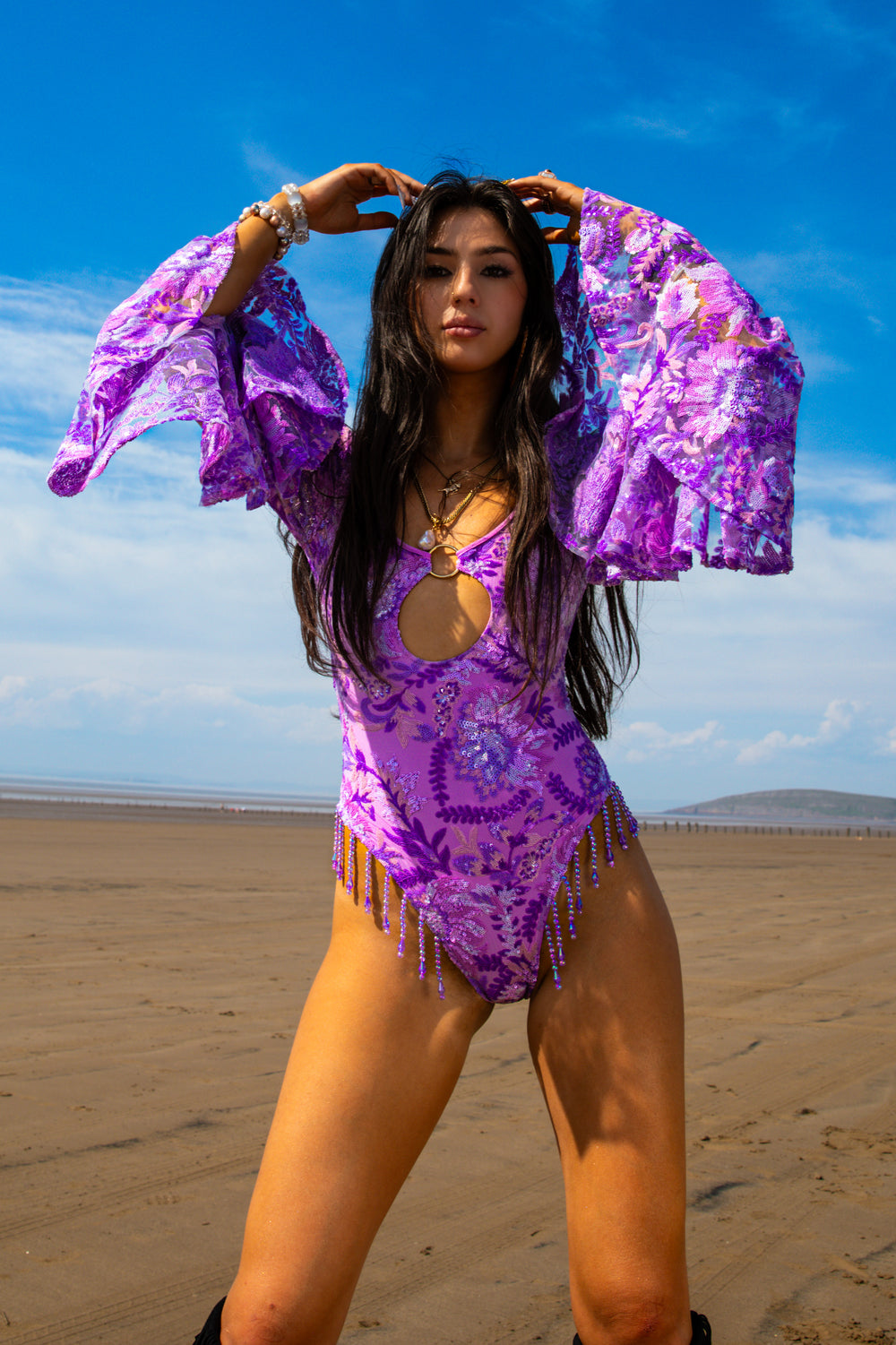 Purple Wild Like Me Flared Bodysuit with dramatic flared sleeves and keyhole cutout, perfect for alternative rave and festival fashion.