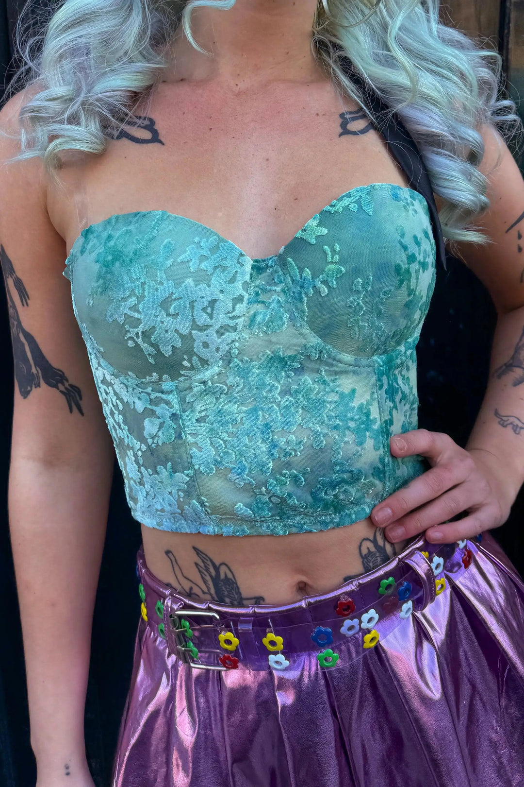 Dixie Velvet Corset Top in teal with floral lace detail, styled for rave and festival wear. Features structured cups and a cropped fit.