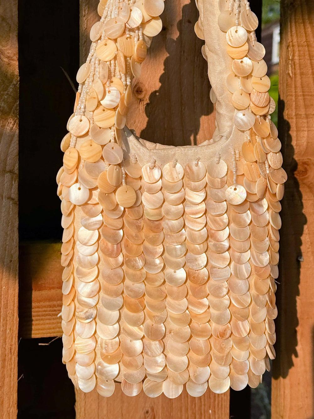 Close-up of Oceana Shell Cream Bag featuring layered shell embellishments. Ideal for alternative festival fashion from Wild Thing.