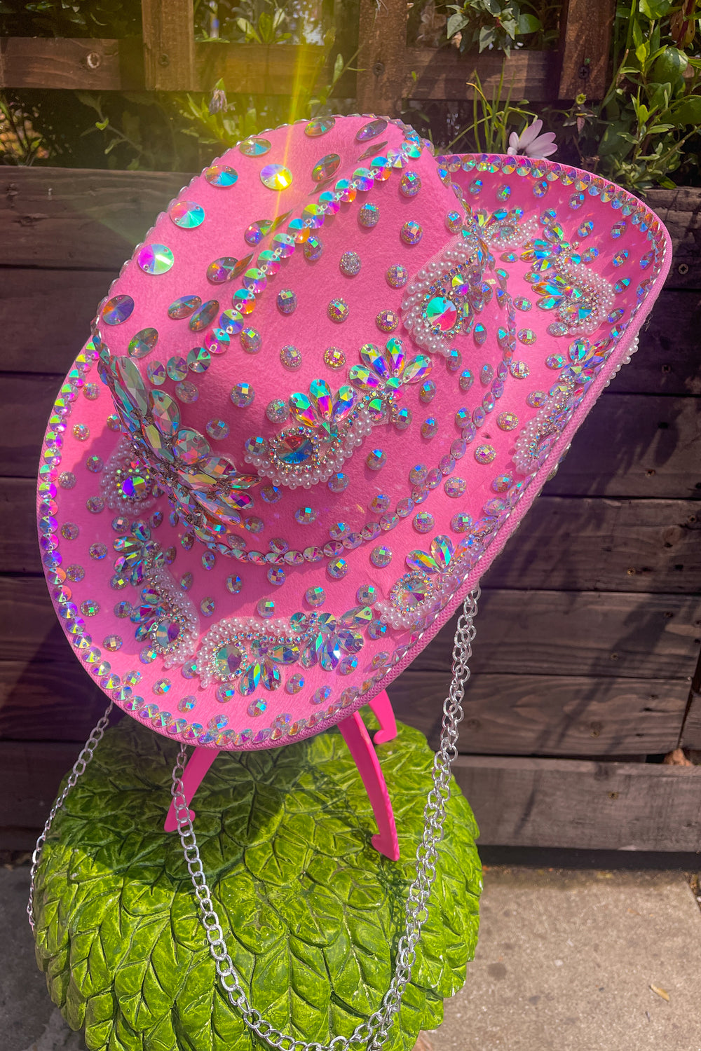 Side view of Pink Rodeo Cowboy Hat with holographic gems and silver chains, ideal for bold rave and festival outfits from Wild Thing.