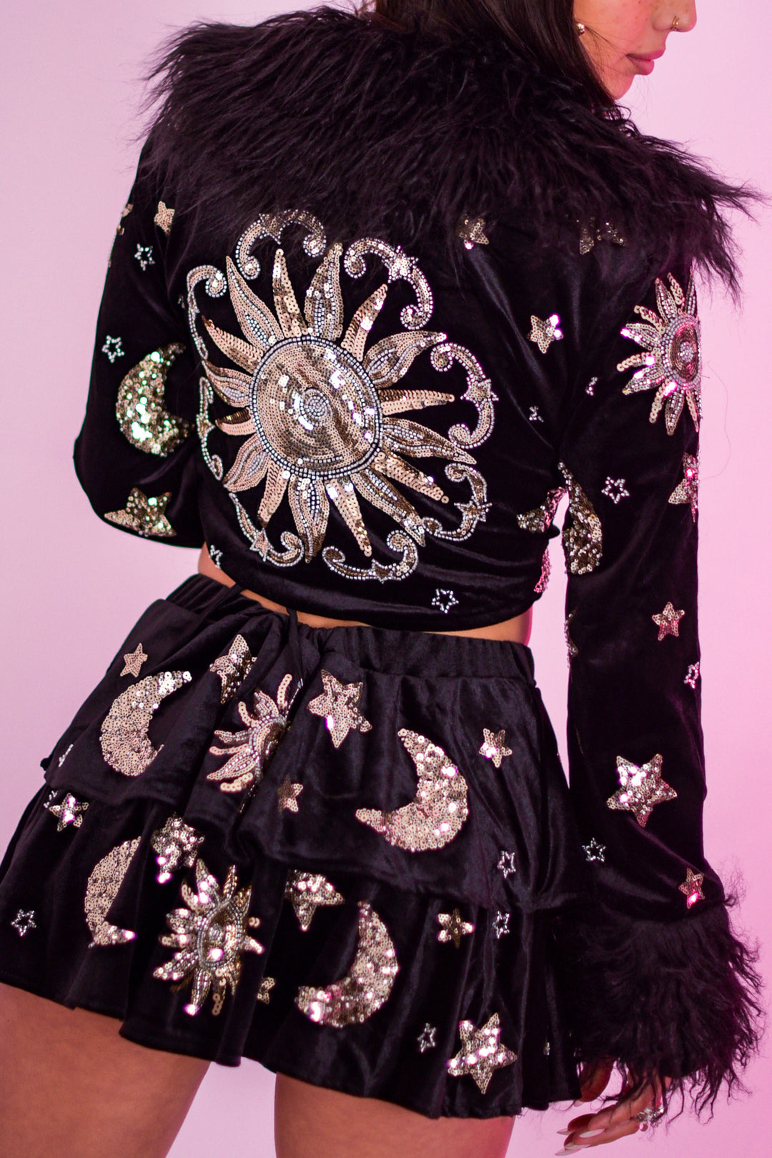The Phase Cropped Jacket with celestial sequin sun and moon embroidery, faux fur collar and cuffs, ideal for rave and festival outfits.