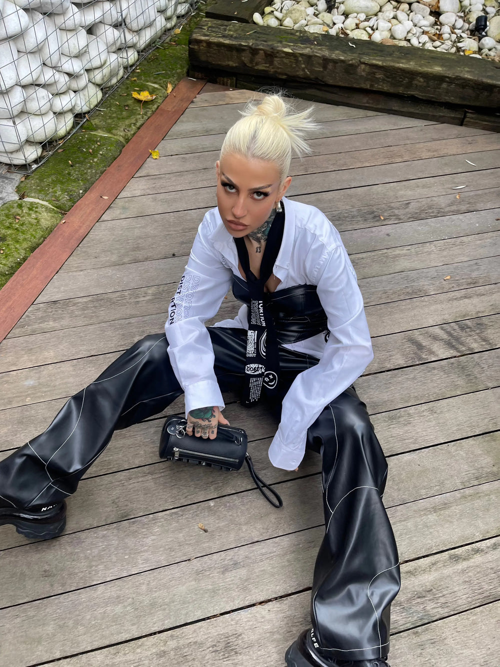 Model wearing Faux Leather Corset with black leather pants and white shirt, edgy rave outfit by independent UK brand on Wild Thing.