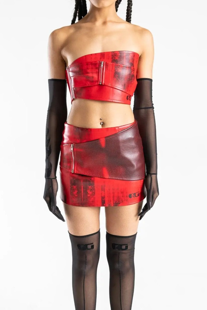 Red faux leather mini skirt with front zip detail, styled with matching tube top and sheer black gloves. Rave and festival clothing on Wild Thing.