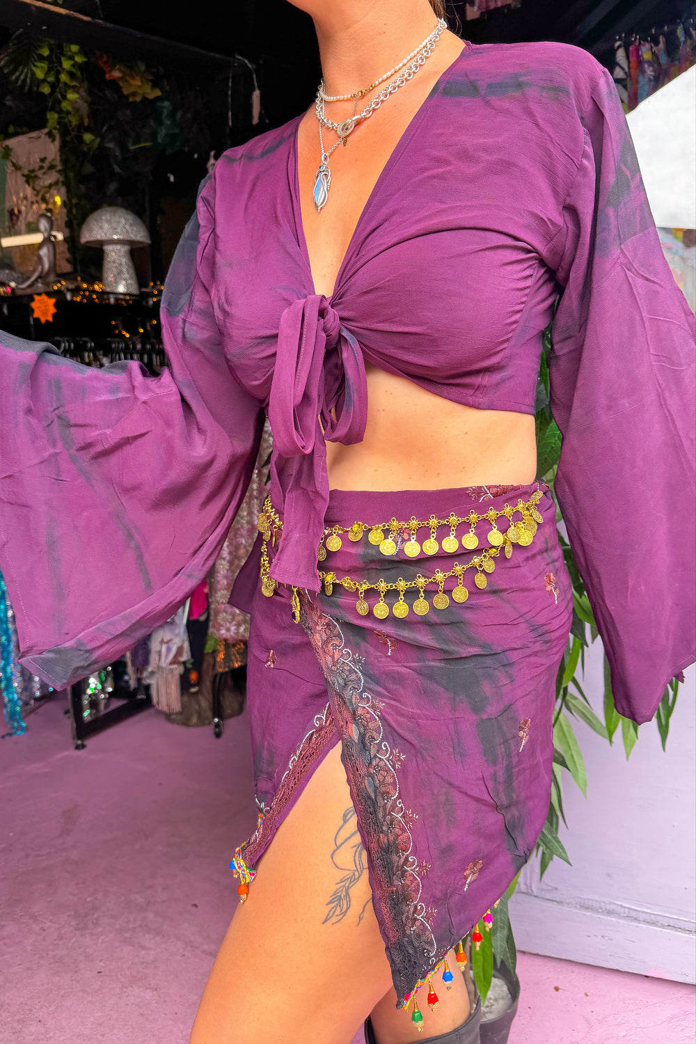 Side view of Sisterhood Skirt Bell Sleeve Set featuring tie-dye accents, bell sleeves, and high-slit skirt, perfect for alternative festival wear.