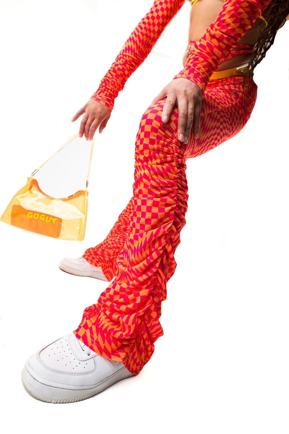 Close-up of All Day All Night Gloves paired with matching flared pants and white sneakers. Vibrant ravewear for festivals and parties.